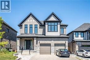 Kitchener apartment for rent - A modern two-story house with a stone facade and a large front yard.