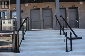 Guelph (Clairfields/Hanlon Business Park) townhouse for rent - A set of stairs with metal handrails lead to a building with three doors.
