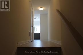 Guelph (Clairfields/Hanlon Business Park) townhouse for rent - A hallway with a Royal LePage logo on the wall.