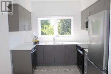 Guelph (Clairfields/Hanlon Business Park) townhouse for rent - A modern kitchen with a window and a sink.