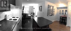 Mississauga (City Centre) condo for rent - A black and white photo of a kitchen and dining area.