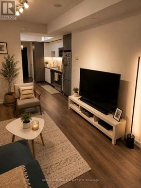 Toronto (Islington-City Centre West) condo for rent - A modern living room with a flat screen TV and a coffee table.