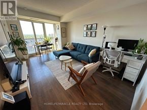 Toronto (Islington-City Centre West) condo for rent - A living room with a blue couch and a television.