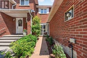 Oakville (Wc Wedgewood Creek) townhouse for rent - A red brick house with a white door and a small window.