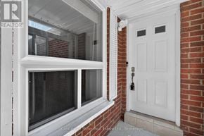 Oakville (Wc Wedgewood Creek) townhouse for rent - A white door with a window on the left side of a brick wall.