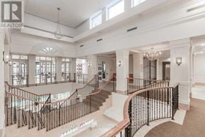 Toronto (West Humber-Clairville) condo for rent - A large, well-lit, and spacious interior of a building with a curved staircase.