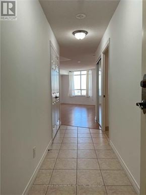 Toronto (West Humber-Clairville) condo for rent - A long hallway with tiled floors and white walls.