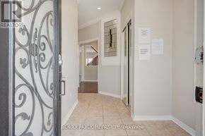 Brampton (Credit Valley) apartment for rent - A hallway with a metal gate on the left and a sign on the wall.