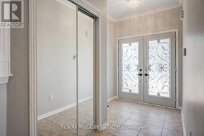 Brampton (Credit Valley) apartment for rent - A white door with a glass panel and a metal handle.