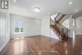 Brampton (Credit Valley) apartment for rent - A spacious room with a wooden floor and a staircase.