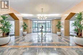 Mississauga (Erin Mills) condo for rent - A lobby with a marble floor and a chandelier.