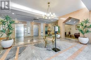 Mississauga (Erin Mills) condo for rent - A lobby with a marble floor and a chandelier.