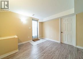 Milton (Be Beaty) apartment for rent - A room with a door, window, and a bed.