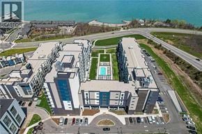 Grimsby condo for rent - A large building with a pool in the middle of a grassy area.