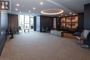 Grimsby condo for rent - A living room with a carpeted floor and a large window.