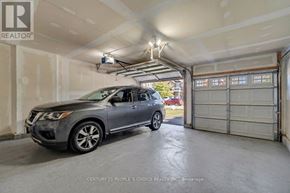 St. Catharines (Secord Woods) apartment for rent - A grey SUV is parked in a garage with a sign that reads "REALTOR".