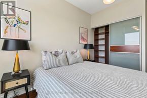 Toronto (Edenbridge-Humber Valley) condo for rent - A bedroom with a bed, nightstand, and a painting on the wall.