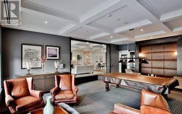 Toronto (Edenbridge-Humber Valley) condo for rent - A living room with a grey carpet and brown leather chairs.