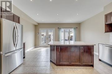Mississauga (Churchill Meadows) apartment for rent - A kitchen with a refrigerator on the left and a counter with a cabinet on the right.