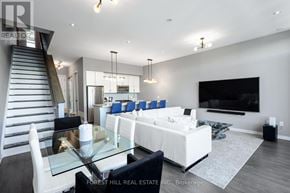 Innisfil townhouse for rent - A modern living room with a glass table and white furniture.