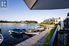 Innisfil townhouse for rent - A boat is docked at a pier in a lake.