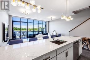 Innisfil townhouse for rent - A modern kitchen with a large island and a view of the outdoors.