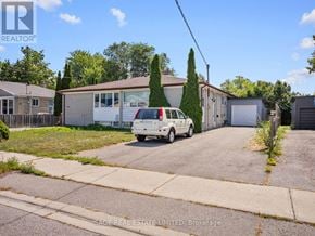 Richmond Hill (Crosby) apartment for rent - A white car is parked in front of a house with a garage.