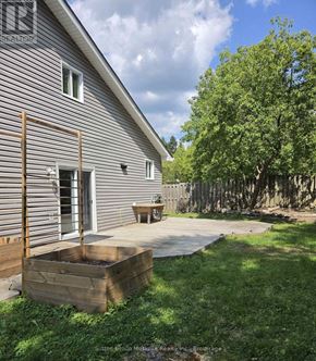 Huntsville apartment for rent - A house with a grey siding and a wooden deck.