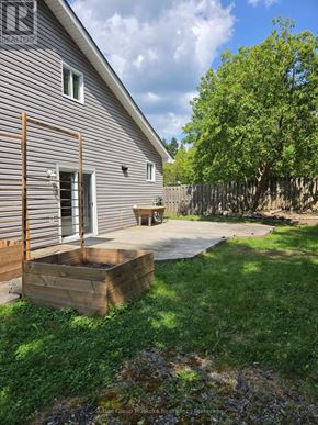 Huntsville apartment for rent - A house with a grey siding and a wooden deck.