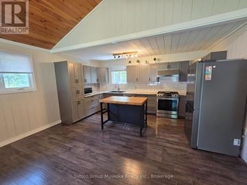 Huntsville apartment for rent - A kitchen with a table and chairs in the middle of the room.