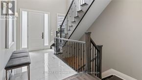 Oakville (Co Central) apartment for rent - A staircase with a black railing and a wooden handrail.