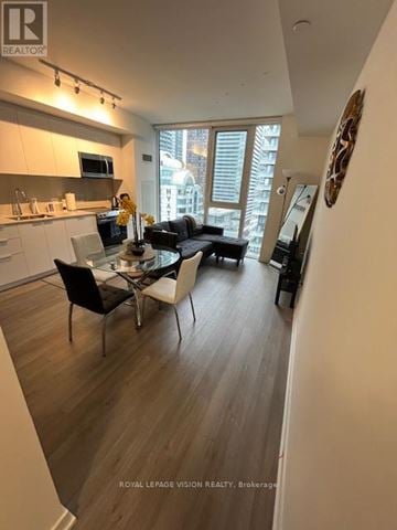 Toronto (Waterfront Communities) condo for rent - A modern kitchen with a dining table and chairs.