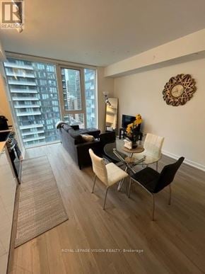 Toronto (Waterfront Communities) condo for rent - A modern dining room with a glass table and chairs.