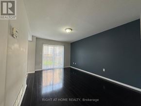 Barrie (Painswick South) apartment for rent - A room with a window and a wall with a light switch.