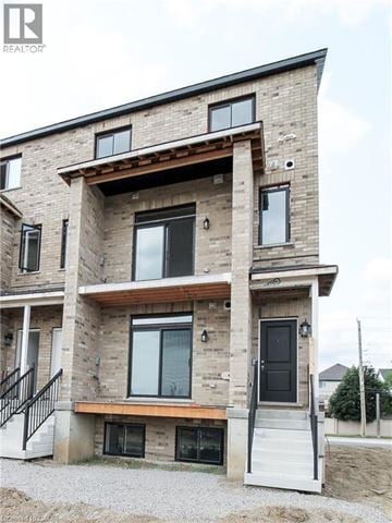 Kitchener townhouse for rent - A modern house with a balcony and a black door.