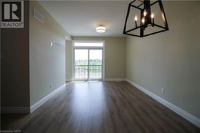 Kitchener townhouse for rent - A room with a wooden floor and a large window.