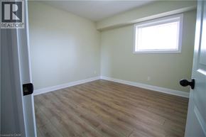 Kitchener townhouse for rent - A room with a window and wooden flooring.