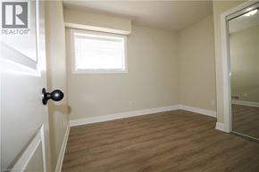 Kitchener townhouse for rent - A room with a wooden floor and a window with blinds.