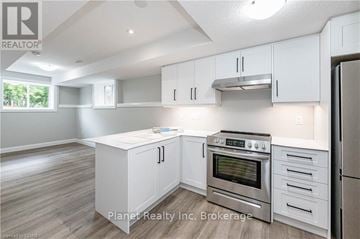 Guelph (Exhibition Park) apartment for rent - A kitchen with white cabinets and stainless steel appliances.