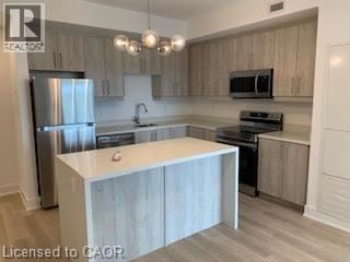 Brantford apartment for rent - A kitchen with a white island in the middle.