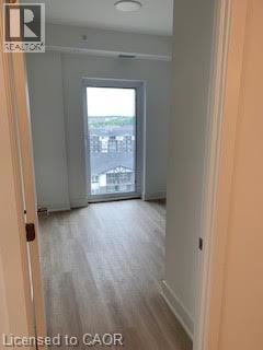 Brantford apartment for rent - A hallway with a door leading to a balcony.