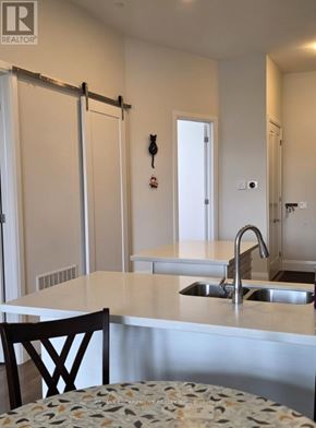 Brantford condo for rent - A kitchen with a sink and a table.