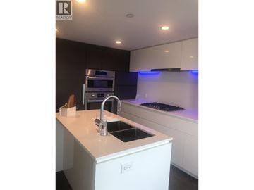 Richmond apartment for rent - A modern kitchen with a sink and a stove.