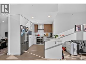 Burnaby apartment for rent - A modern kitchen with a refrigerator, oven, and sink.