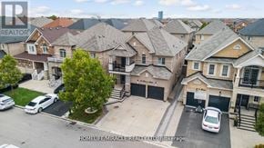 Brampton (Credit Valley) apartment for rent - A brokerage company logo is visible on the top left corner of an aerial view of a residential area.