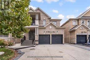 Brampton (Credit Valley) apartment for rent - A large, well-maintained house with a driveway and garage doors.