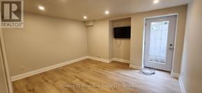 Oakville (Ro River Oaks) apartment for rent - A room with a door and a flat screen TV mounted on the wall.