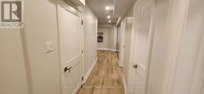 Oakville (Ro River Oaks) apartment for rent - A hallway with white walls and wood floors.