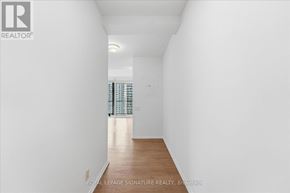 Toronto (Waterfront Communities) condo for rent - A white room with a wooden floor and a window with blinds.
