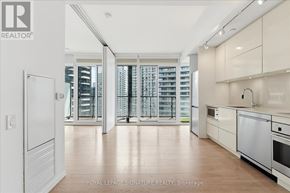 Toronto (Waterfront Communities) condo for rent - A modern kitchen with white appliances and wooden floors.